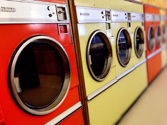 A row of red and yellow commercial dryers.