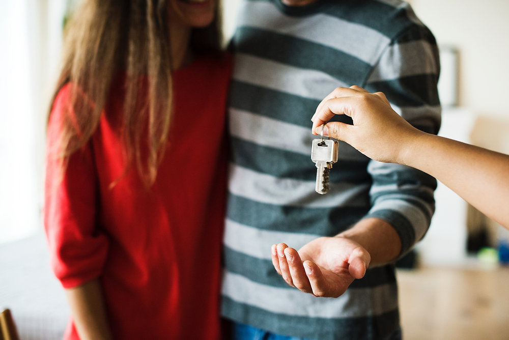 Couple receiving the keys to a new home.